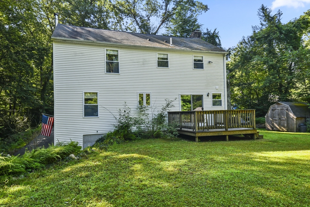 549 Chestnut Hill Road Millville, MA 01529 - Photo 30 of 38 a view of a house with a backyard and deck