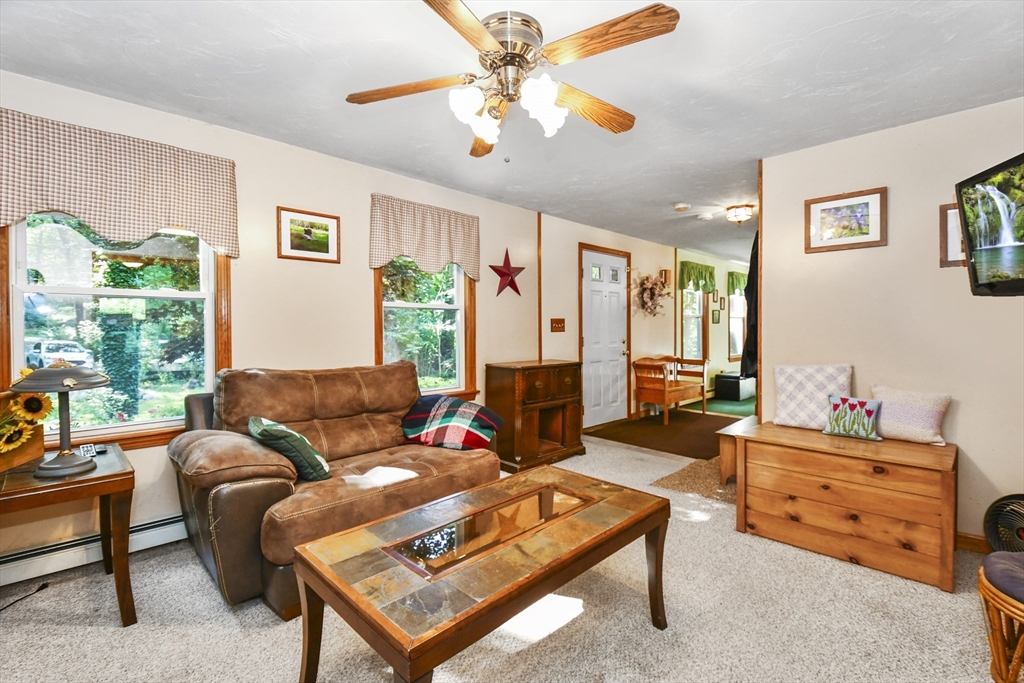 549 Chestnut Hill Road Millville, MA 01529 - Photo 3 of 38 a living room with furniture a table and a window
