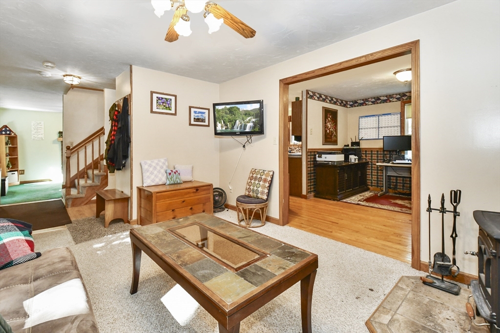 549 Chestnut Hill Road Millville, MA 01529 - Photo 4 of 38 a living room with furniture a flat screen tv and a table