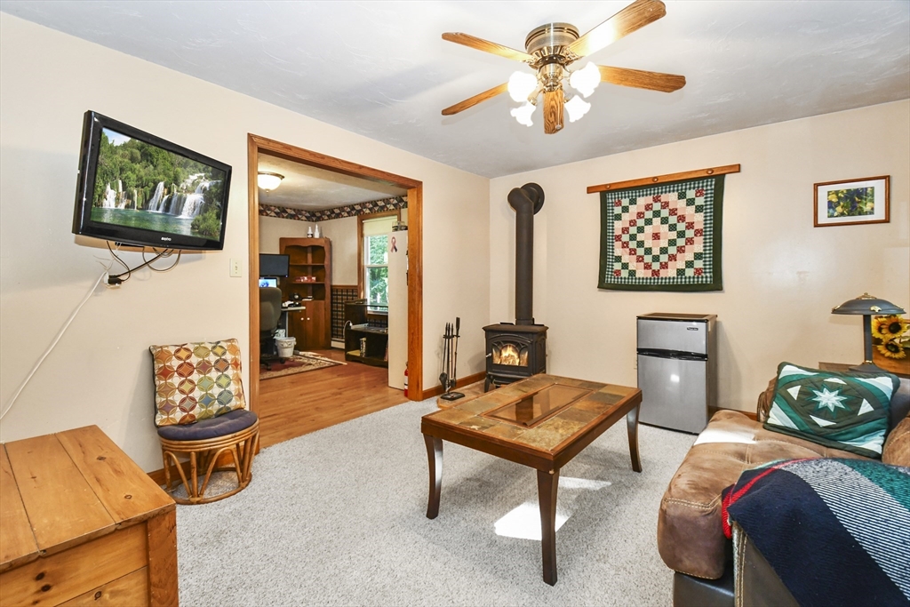 549 Chestnut Hill Road Millville, MA 01529 - Photo 5 of 38 a bedroom with furniture and a lamp