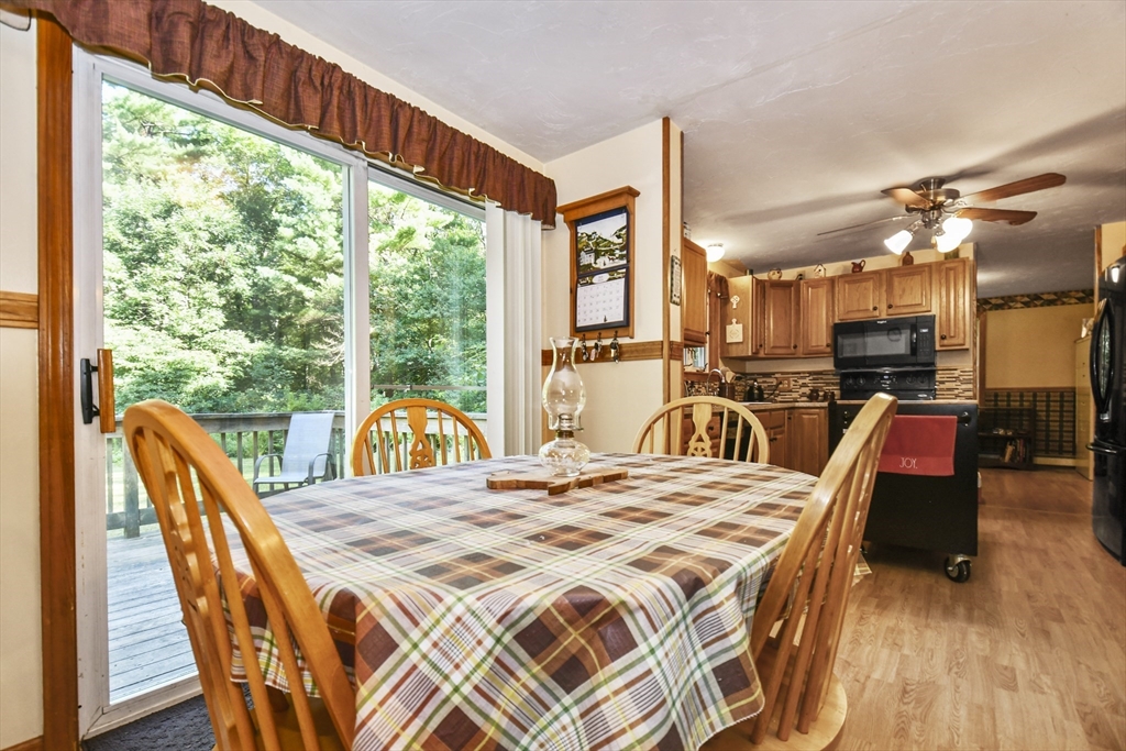 549 Chestnut Hill Road Millville, MA 01529 - Photo 9 of 38 a view of a dining room with furniture a chandelier and wooden floor