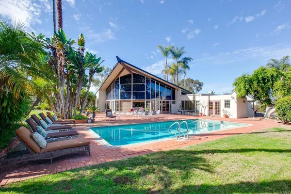 a front view of house with yard and outdoor seating