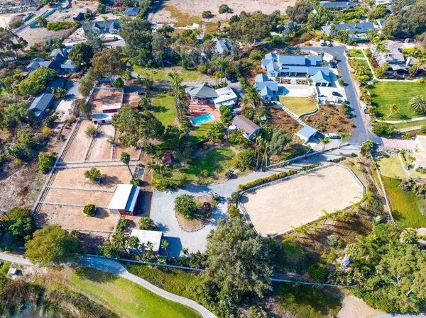 an aerial view of residential houses with outdoor space and swimming pool