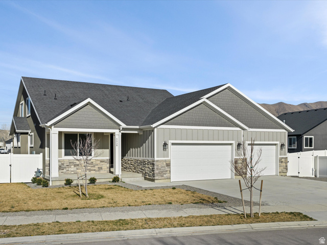 3938 North Wood Road Eagle Mountain, UT 84005 - Photo 2 of 55 Craftsman house featuring a gate, stone siding, driveway, and a garage