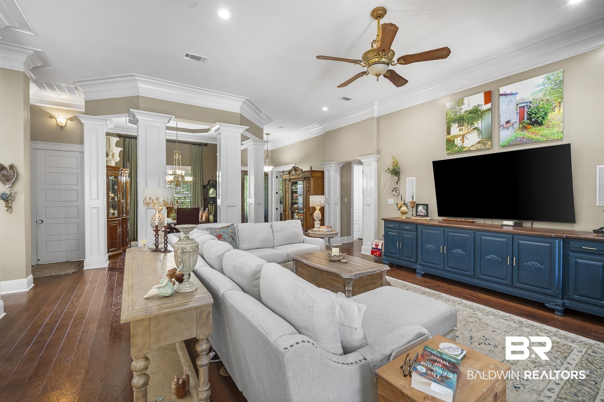 25212 Austin Road Daphne, AL 36526 - Photo 15 of 56 Living room with ornate columns, dark wood-style floors, ornamental molding, recessed lighting, and a ceiling fan