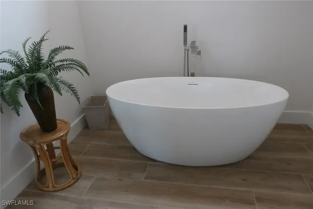 a white bath tub sitting in a bathroom