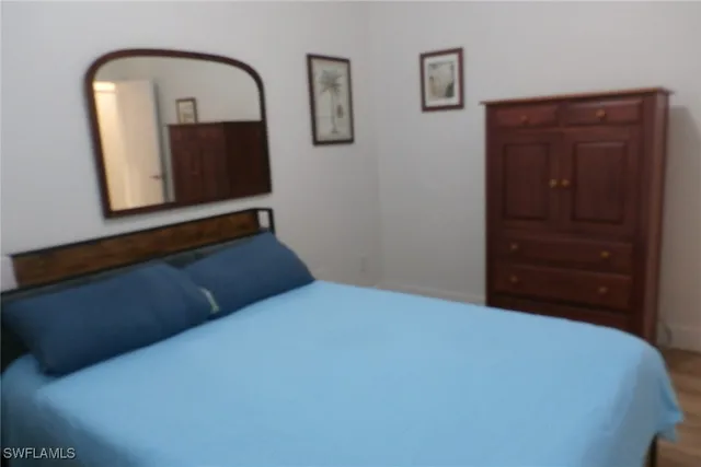 a bedroom with a bed and a dresser