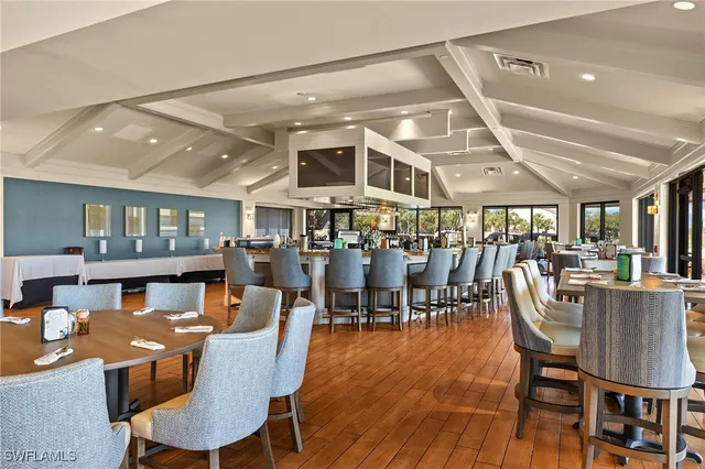 a dining room with lots of wooden furniture and a chandelier