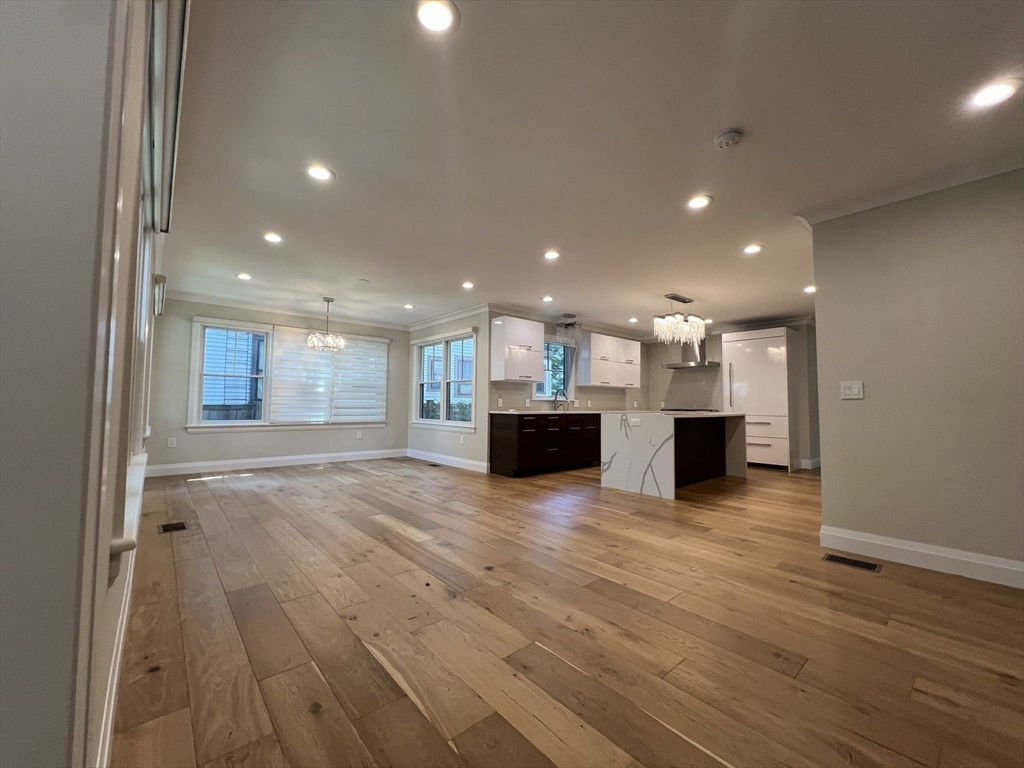 23 Winslow Road, Unit 1 Brookline, MA 02446 - Photo 3 of 27 a view of kitchen with kitchen island sink and center island