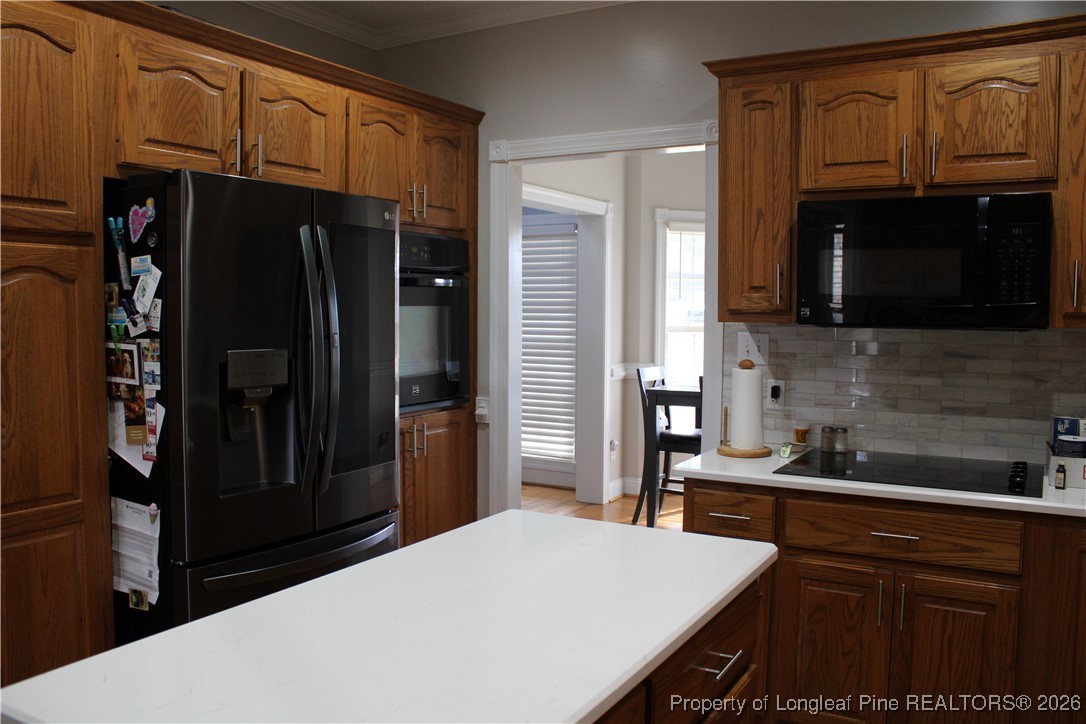 573 Porter Road Hope Mills, NC 28348 - Photo 10 of 29 a kitchen with stainless steel appliances a refrigerator and a stove top oven