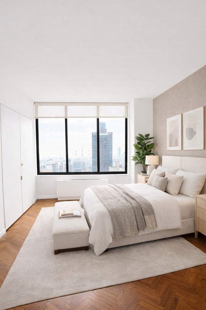 200-210 East 65th Street, Unit 30E Manhattan, NY 10065 - Photo 12 of 17 a bedroom with a large bed and a large window