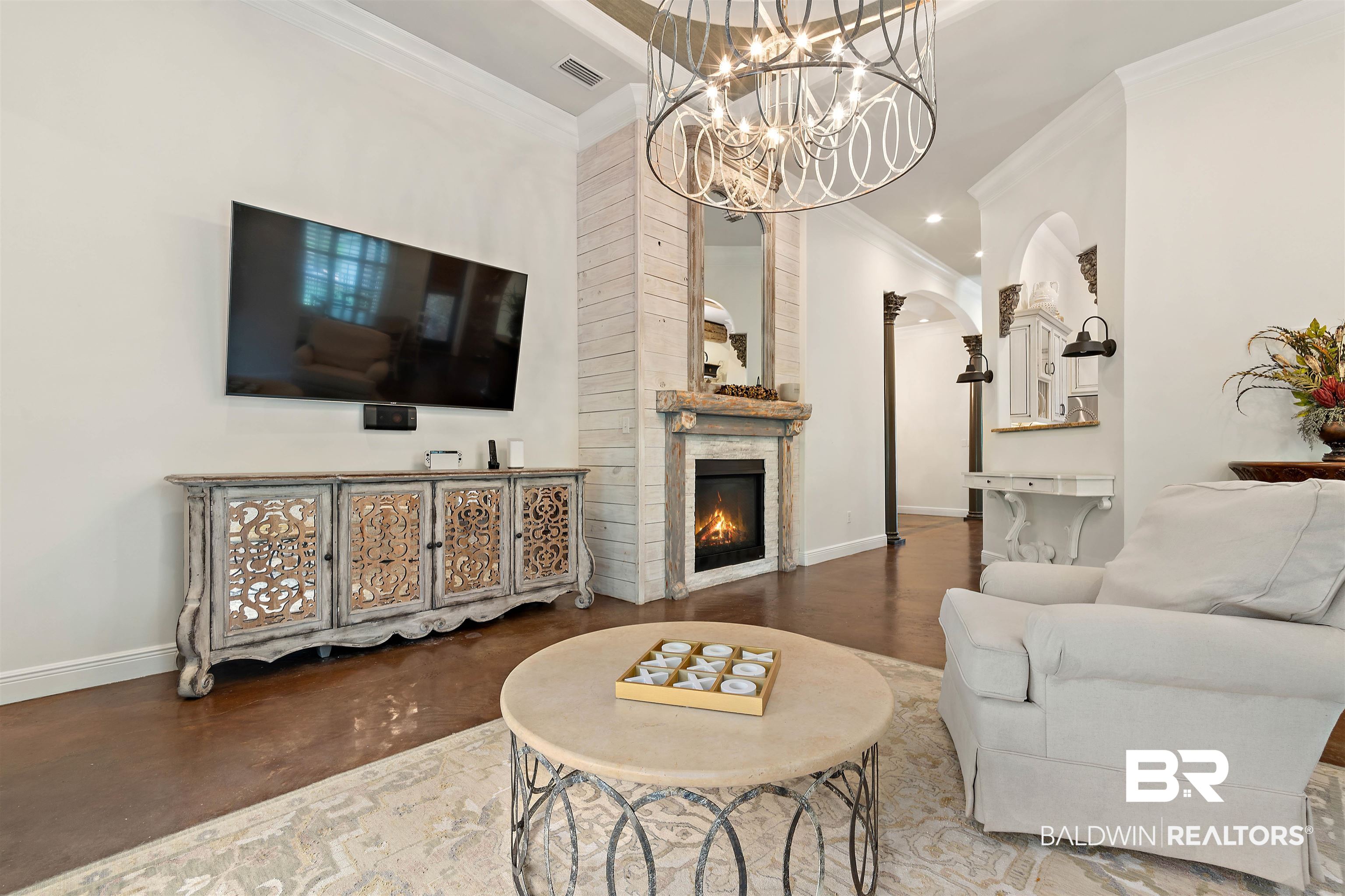 3584 Rue Royal Mobile, AL 36693 - Photo 7 of 35 Living area featuring a warm lit fireplace, baseboards, and ornamental molding