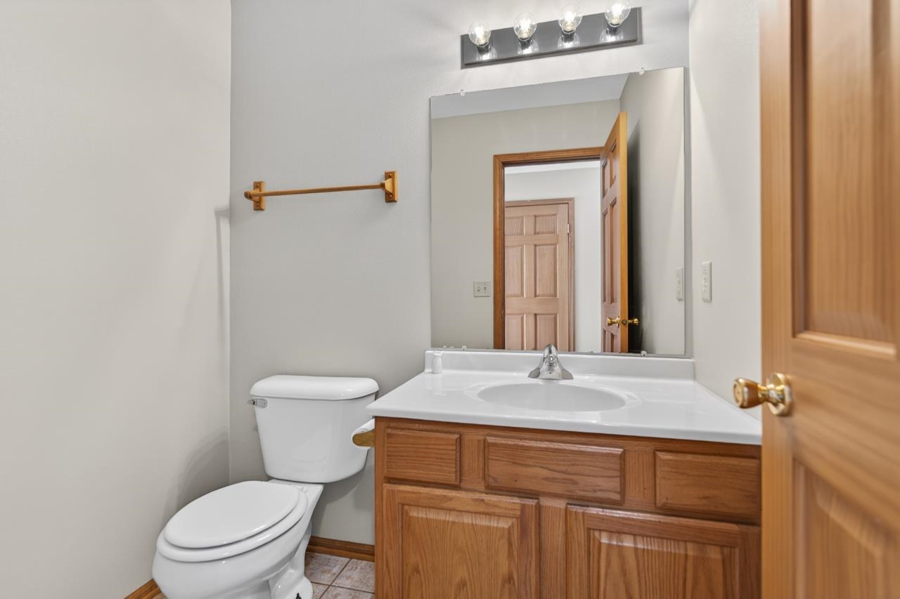 676 Elberon Way Roscoe, IL 61073 - Photo 15 of 30 a bathroom with a sink a toilet and mirror