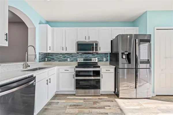 a kitchen with a refrigerator stove and sink