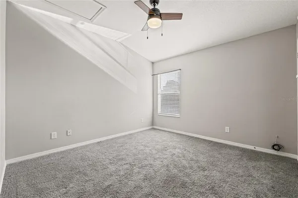 a view of empty room with a ceiling fan