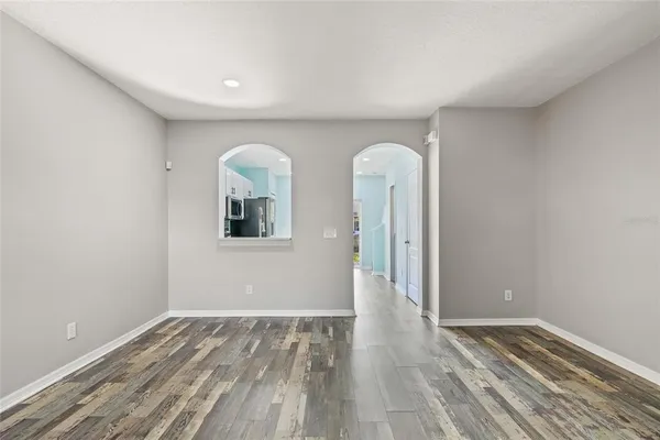a view of a room with wooden floor and window