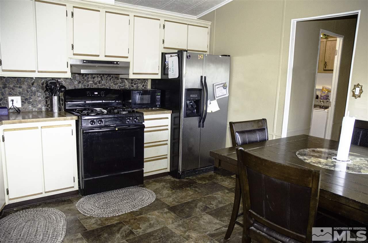 1465 Kate Lane Reno, NV 89506 - Photo 6 of 10 a kitchen with stainless steel appliances granite countertop a stove refrigerator and microwave