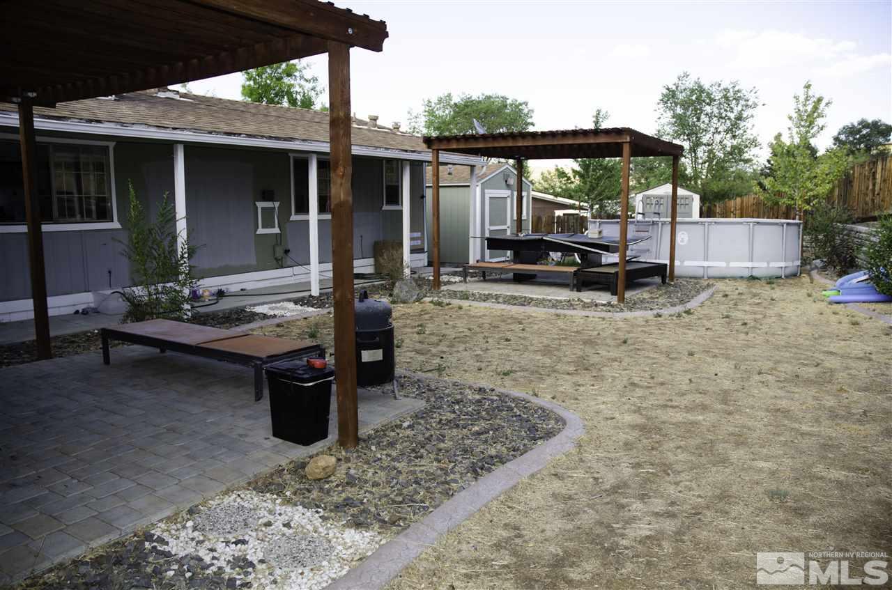 1465 Kate Lane Reno, NV 89506 - Photo 9 of 10 a backyard of a house with barbeque oven table and chairs