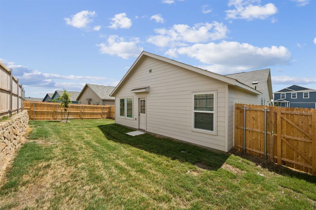 11522 Gammon Avenue Rhome, TX 76078 - Photo 24 of 25 Back of house featuring a fenced backyard