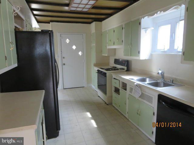6220 Liberty Road Baltimore, MD 21207 - Photo 3 of 9 a kitchen with stainless steel appliances a stove a sink and a refrigerator