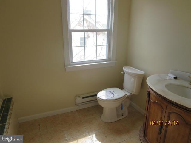 6220 Liberty Road Baltimore, MD 21207 - Photo 5 of 9 a white toilet sitting next to a bathroom sink