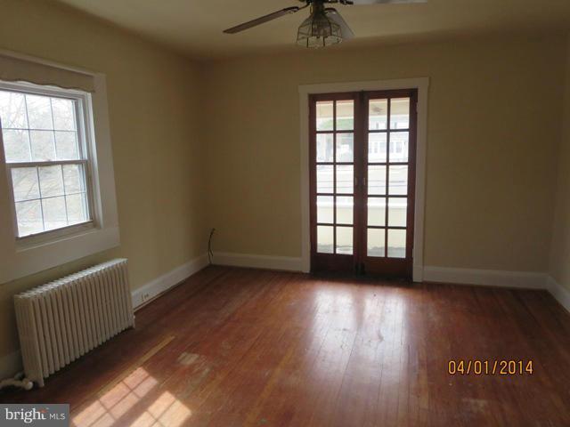 6220 Liberty Road Baltimore, MD 21207 - Photo 6 of 9 an empty room with wooden floor and windows