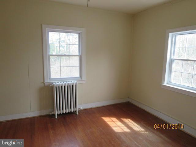 6220 Liberty Road Baltimore, MD 21207 - Photo 8 of 9 an empty room with wooden floor and windows