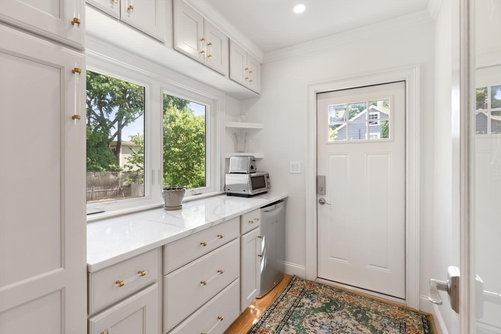 155 Adams Avenue Newton, MA 02465 - Photo 12 of 37 a kitchen with white cabinets and window