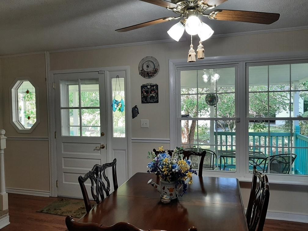 1345 Cowan Road Dickson, TN 37055 - Photo 16 of 68 a dining room with wooden floor a chandelier a glass table and chairs