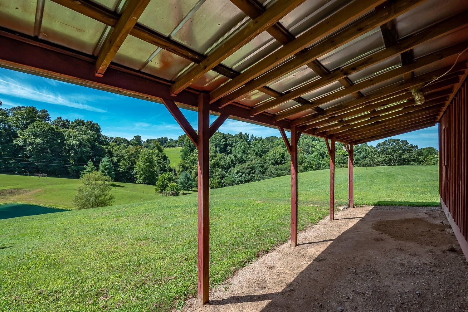 1345 Cowan Road Dickson, TN 37055 - Photo 42 of 68 a view of a backyard with table and chairs under a large umbrella