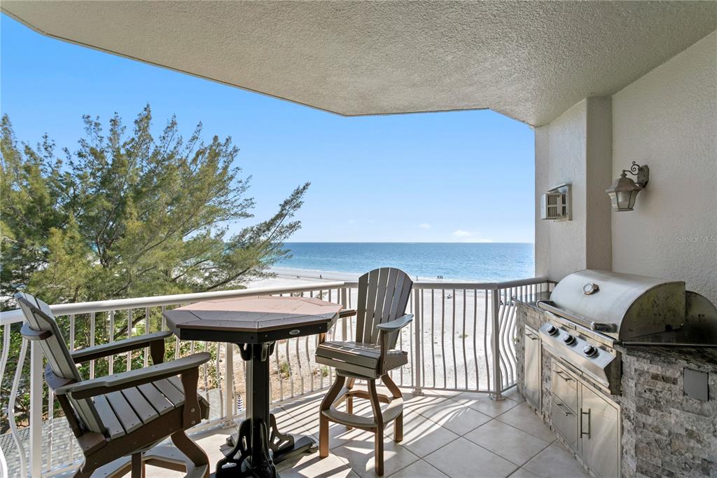 19730 Gulf Boulevard, Unit 400 Indian Rocks Beach, FL 33785 - Photo 27 of 90 a view of a chairs and table on the deck