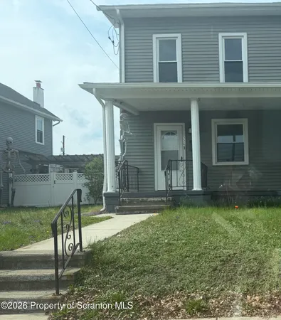 a view of a house with backyard and porch