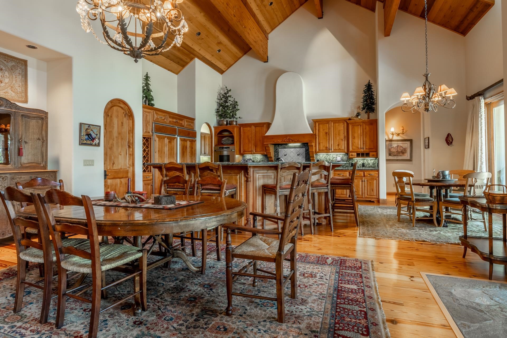 45 Skyline Road June Lake, CA 93529 - Photo 15 of 58 Spacious interior featuring vaulted wood-paneled ceilings with exposed beams, hardwood flooring, and multiple chandeliers