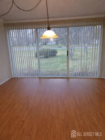 a living room with furniture a window and a flat screen tv