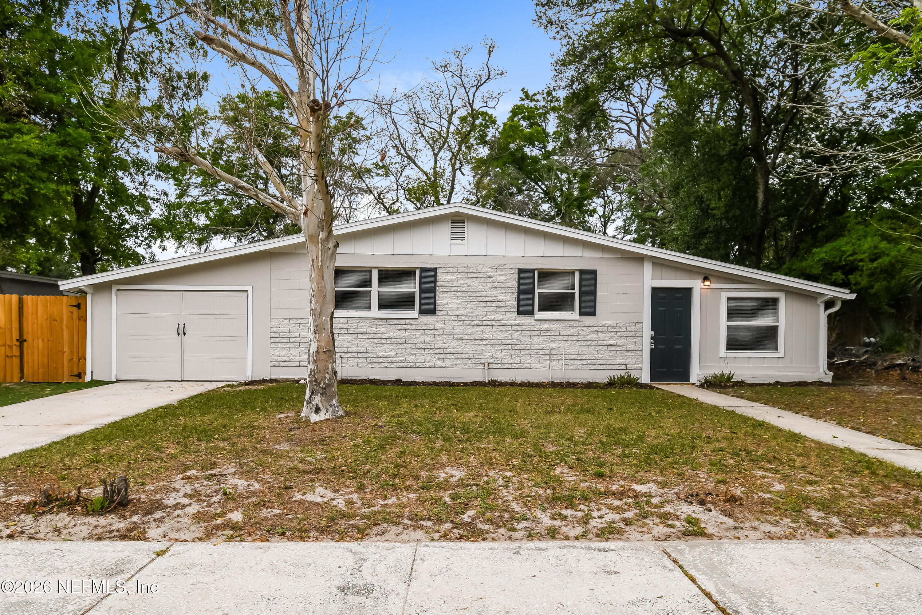 7227 Stonehurst Road North Jacksonville, FL 32277 - Photo 1 of 16 a backyard of a house with yard and garage