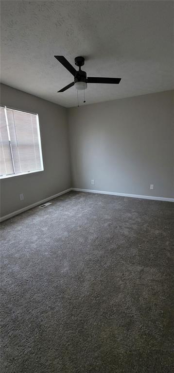 2085 Lenoa Lane Austell, GA 30106 - Photo 12 of 14 an empty room with a ceiling fan and a window