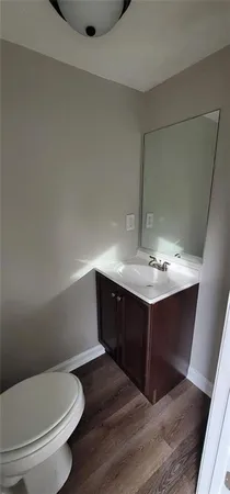 a bathroom with a sink vanity and toilet