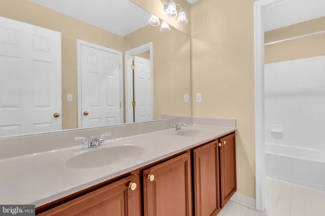 a bathroom with a sink double vanity and a mirror