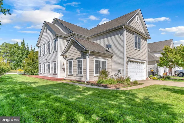 a front view of a house with a garden and yard