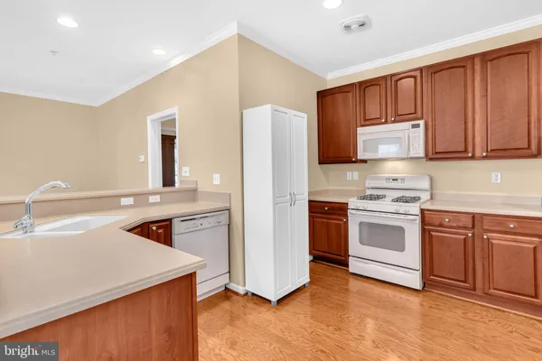 a kitchen with a sink stove and refrigerator