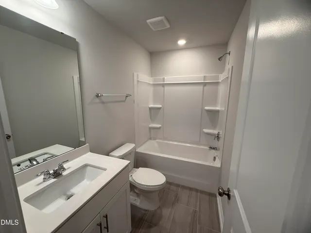 a bathroom with a sink toilet tub and shower