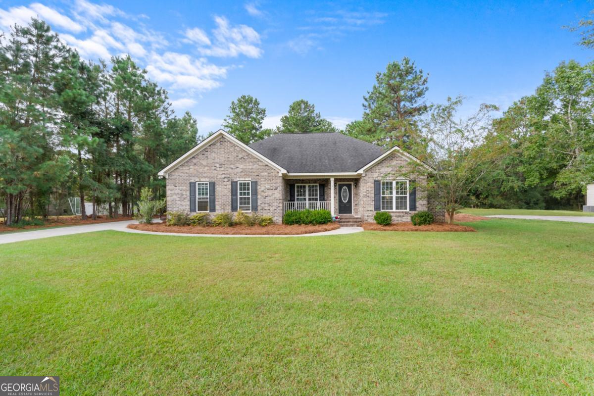 a front view of house with yard and green space