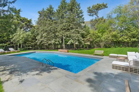 a view of a swimming pool with a yard