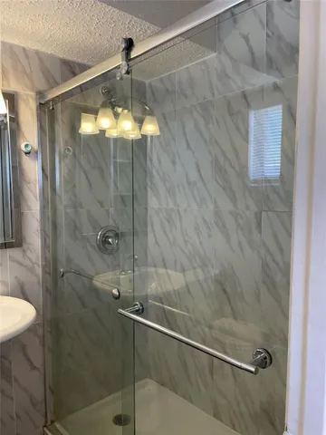 a bathroom with a shower and a toilet