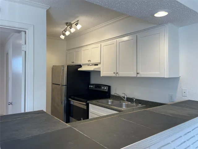 a view of kitchen with cabinets and stainless steel appliances