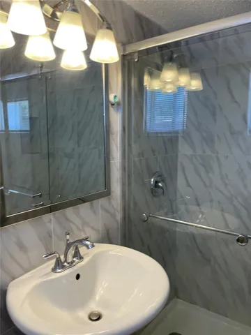 a bathroom with a sink and shower