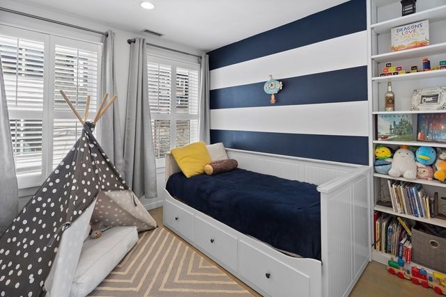 a living room with furniture and a book shelf