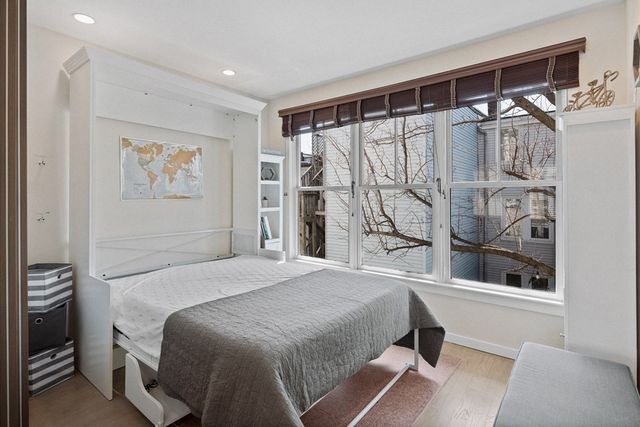 a bedroom with a large bed and a window