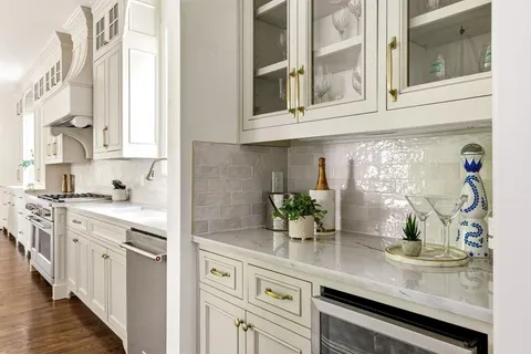 a kitchen with stainless steel appliances granite countertop a sink a stove and cabinets