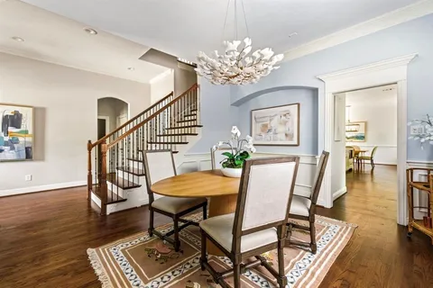 a view of a dining room with furniture wooden floor and chandelier